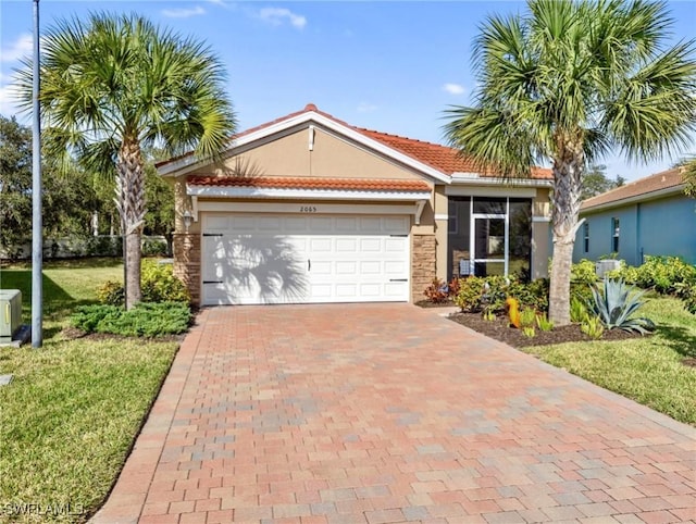 view of front of property featuring a garage, a front yard, decorative driveway, and stucco siding