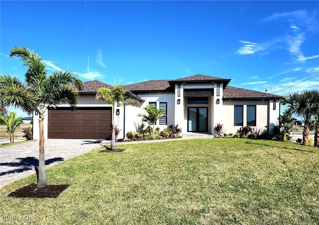 view of front of property featuring a garage and a front yard