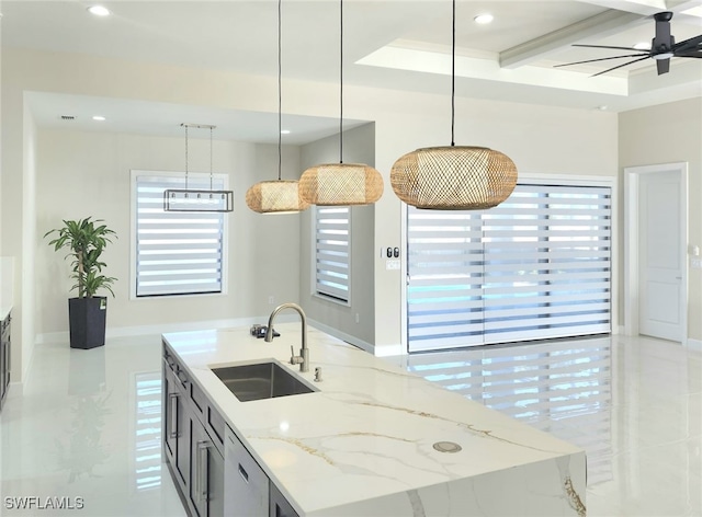 kitchen with sink, decorative light fixtures, stainless steel dishwasher, an island with sink, and light stone countertops