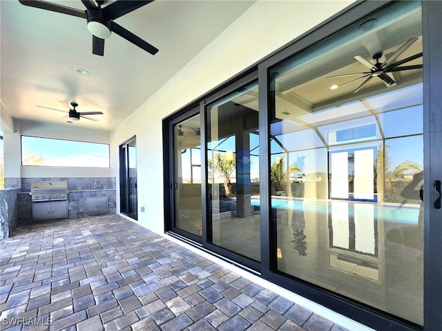 view of patio / terrace with a grill, ceiling fan, and glass enclosure