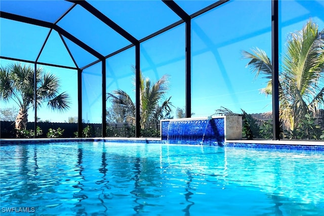 view of pool featuring pool water feature and a lanai