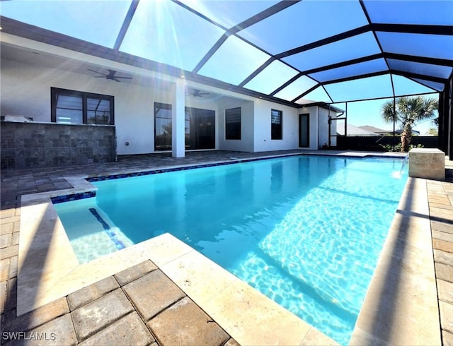 view of pool with a patio, a lanai, and ceiling fan