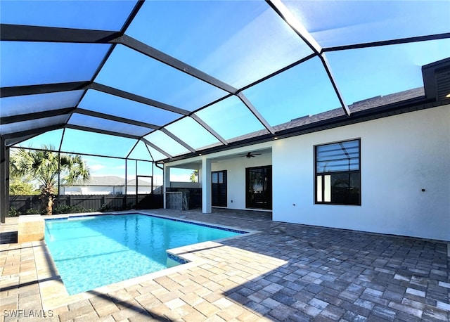 view of pool with a patio, a lanai, and ceiling fan