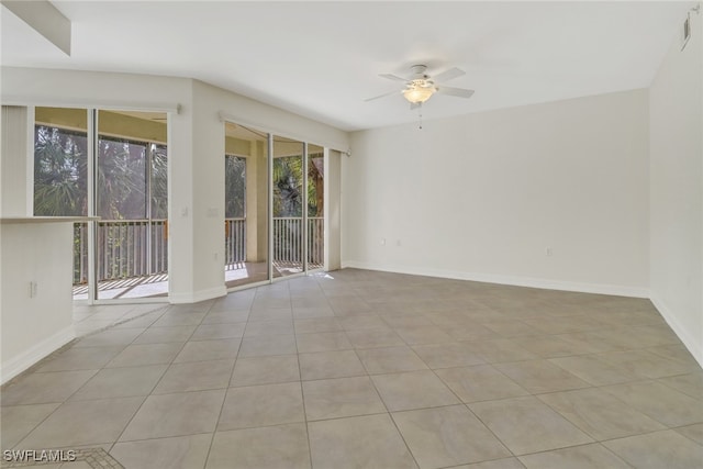 tiled spare room with ceiling fan