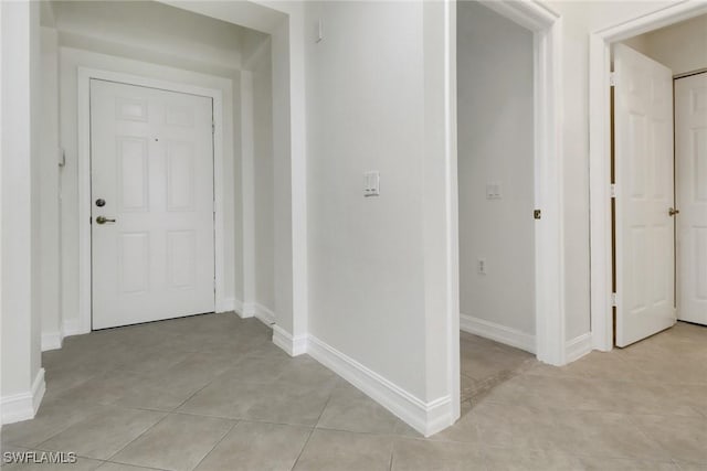 hall with light tile patterned flooring