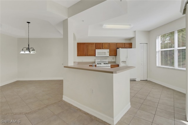 kitchen with hanging light fixtures, white appliances, kitchen peninsula, and light tile patterned floors