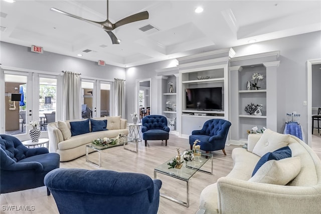 living room featuring french doors, coffered ceiling, ceiling fan, light hardwood / wood-style floors, and built in shelves