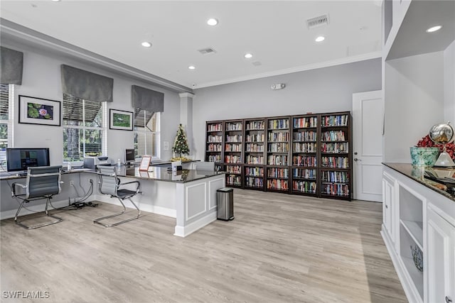 office area with ornamental molding and light wood-type flooring