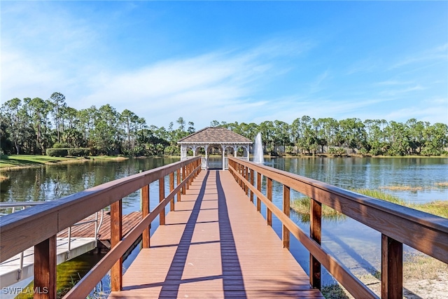 view of dock featuring a gazebo and a water view