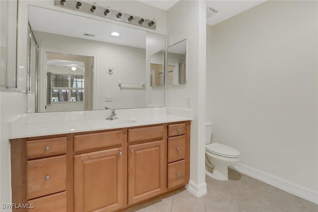 bathroom featuring tile patterned flooring, vanity, and toilet