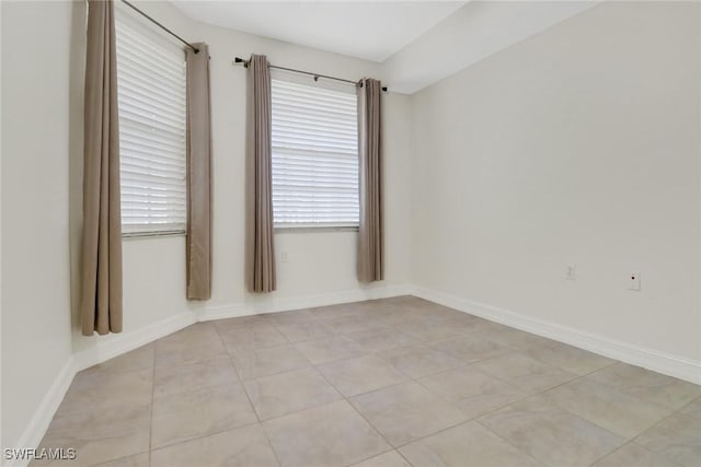 tiled empty room with a wealth of natural light