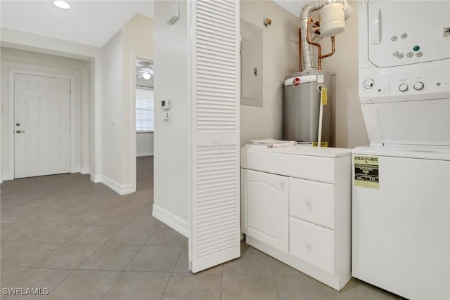 laundry room with stacked washer and dryer, light tile patterned floors, electric panel, and water heater