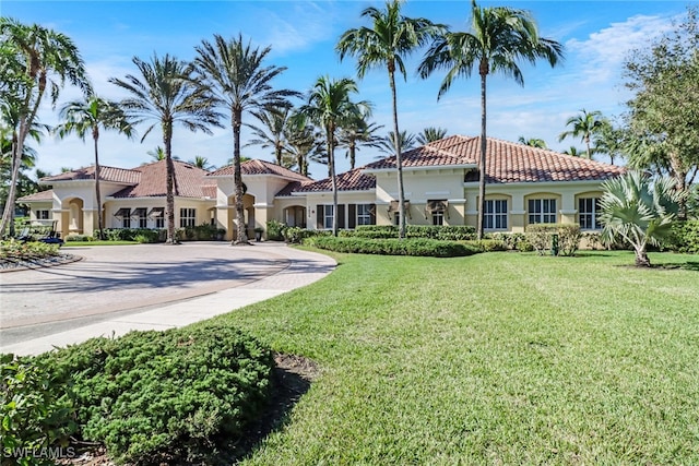 mediterranean / spanish-style home featuring a front lawn