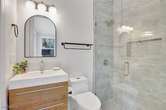 bathroom featuring vanity, toilet, and walk in shower