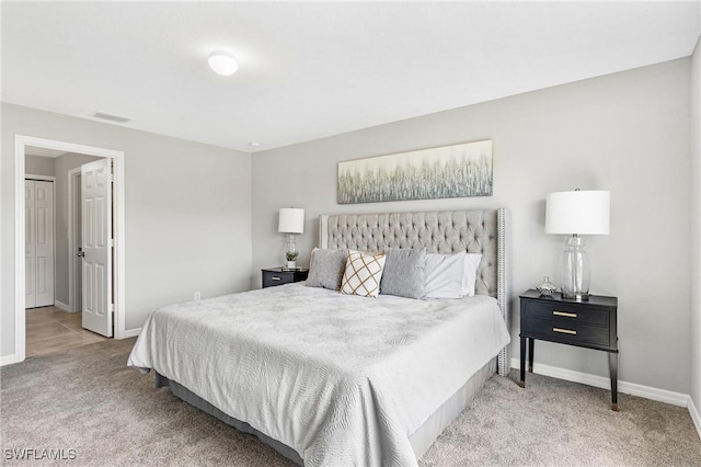 bedroom featuring light colored carpet