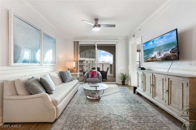 living room featuring ornamental molding, ceiling fan, and dark hardwood / wood-style flooring