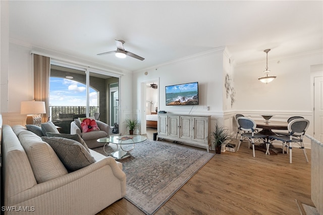 living room featuring crown molding, ceiling fan, and hardwood / wood-style floors