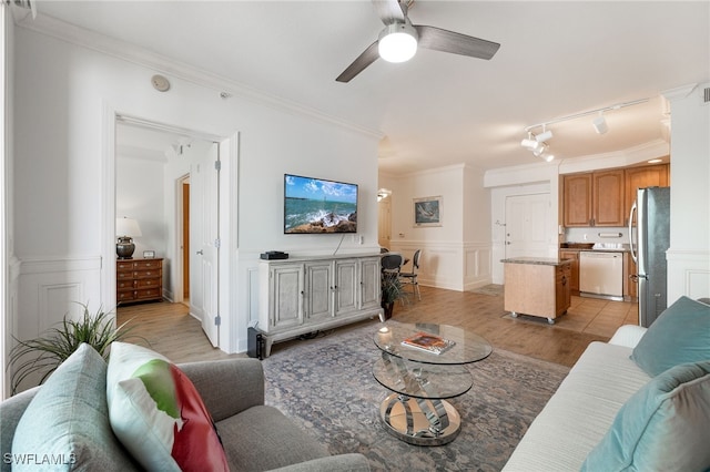 living room with crown molding, light hardwood / wood-style flooring, ceiling fan, and track lighting