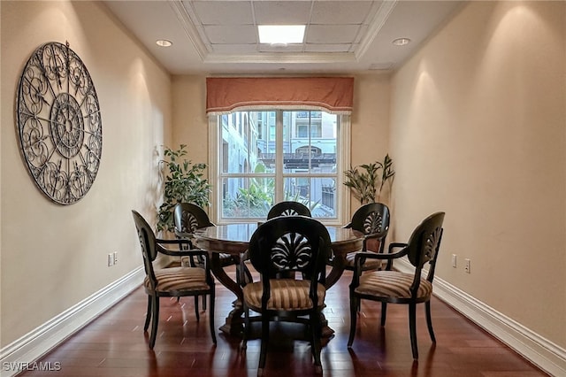 dining room with dark hardwood / wood-style flooring and a raised ceiling