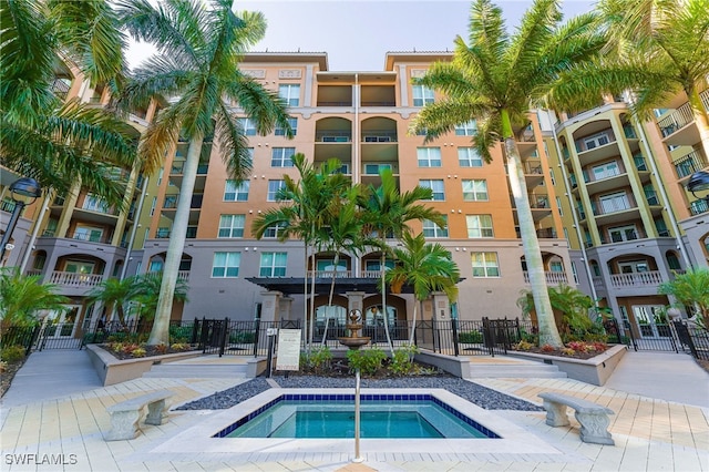 view of swimming pool with a community hot tub