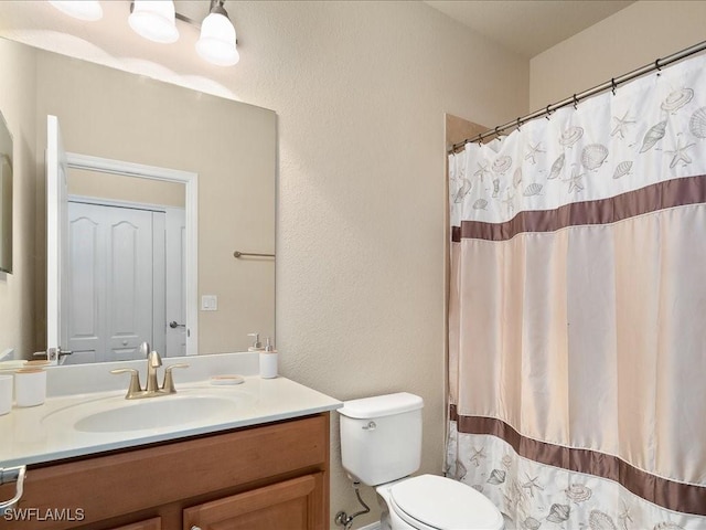 bathroom featuring vanity, toilet, and a shower with shower curtain