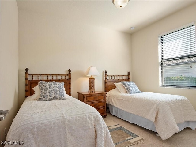 bedroom featuring light carpet