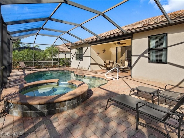 exterior space with an in ground hot tub, ceiling fan, a lanai, and a patio area