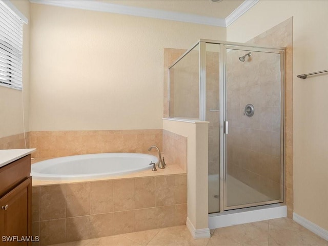 bathroom with tile patterned floors, ornamental molding, shower with separate bathtub, and vanity