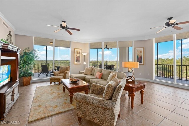 living room with expansive windows, crown molding, and a healthy amount of sunlight