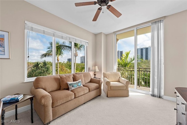 living room with carpet, a healthy amount of sunlight, and ceiling fan