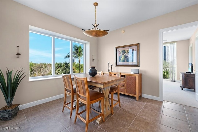 dining space with tile patterned floors and baseboards