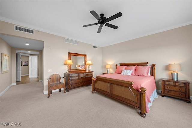 carpeted bedroom featuring crown molding and ceiling fan