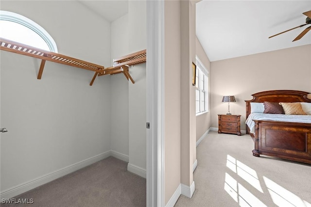 bedroom with lofted ceiling, light carpet, and ceiling fan