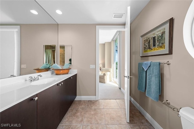 bathroom with vanity, tile patterned flooring, and toilet