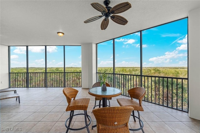 sunroom with a wealth of natural light and ceiling fan