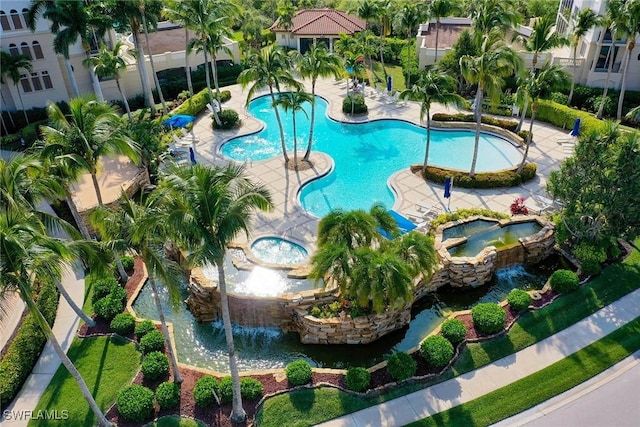 view of swimming pool with a hot tub and a patio