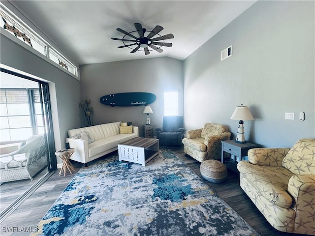 living room with ceiling fan, dark hardwood / wood-style flooring, and vaulted ceiling