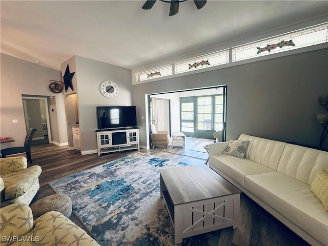 living room featuring ceiling fan, vaulted ceiling, and dark hardwood / wood-style flooring