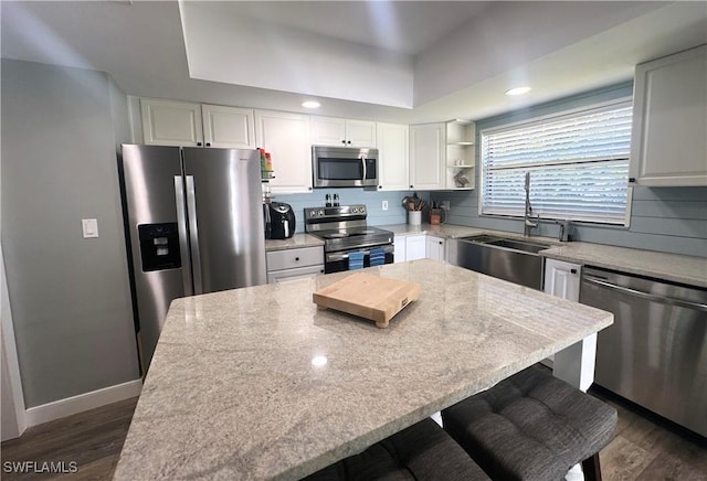 kitchen featuring white cabinetry, appliances with stainless steel finishes, and a center island