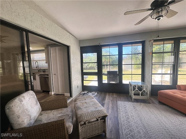 sunroom / solarium with ceiling fan and sink