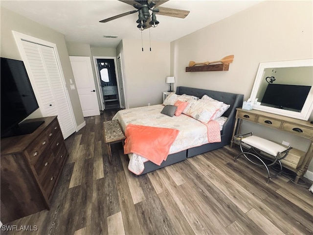 bedroom featuring ensuite bath, dark hardwood / wood-style floors, and ceiling fan