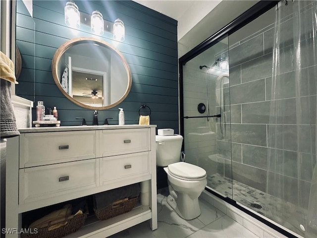 bathroom featuring vanity, toilet, and an enclosed shower