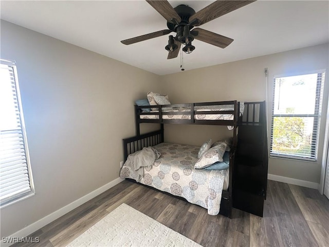 bedroom with ceiling fan and dark hardwood / wood-style floors