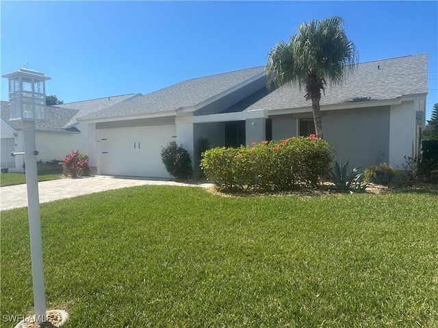 ranch-style home with a garage and a front yard