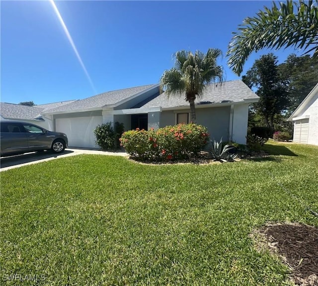 view of front of property with a garage, a front yard, and stucco siding