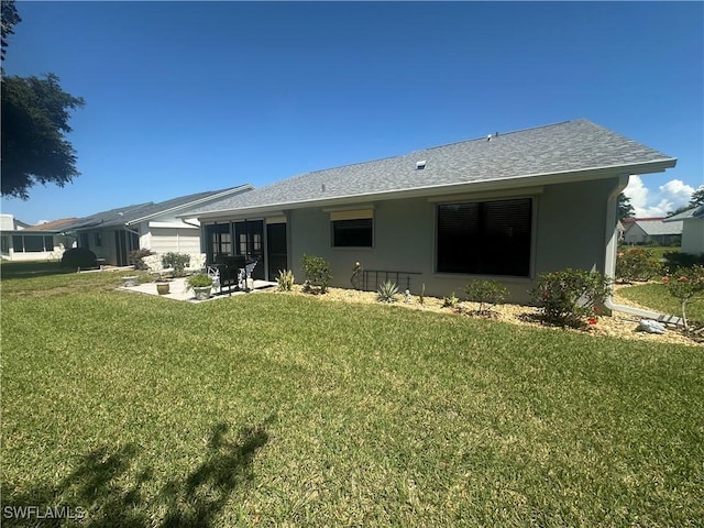 16660 Coriander Ln, Fort Myers, FL 33908 - rear view of house featuring a lawn, stucco siding, a patio area, and roof with shingles