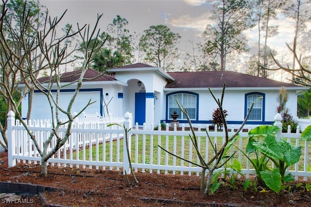 view of front of house with a garage and a front lawn