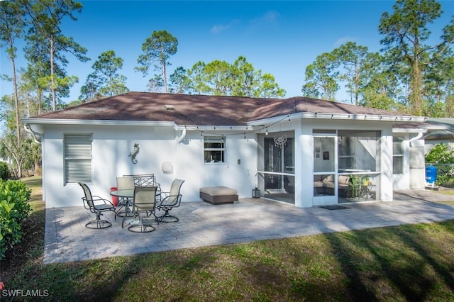 back of house with a patio area and a sunroom