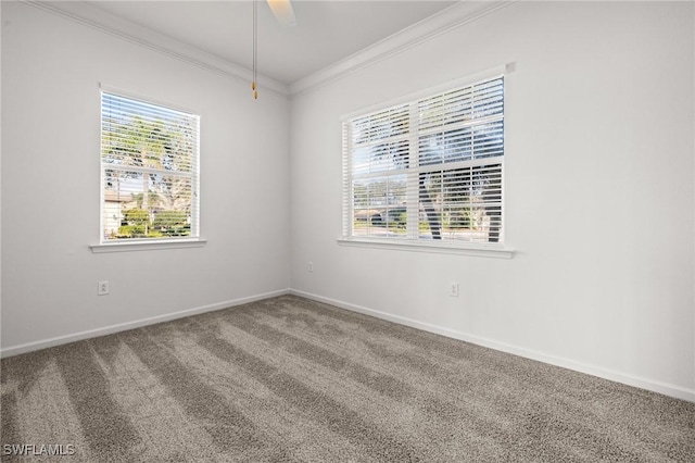 unfurnished room with carpet floors, baseboards, ornamental molding, and ceiling fan