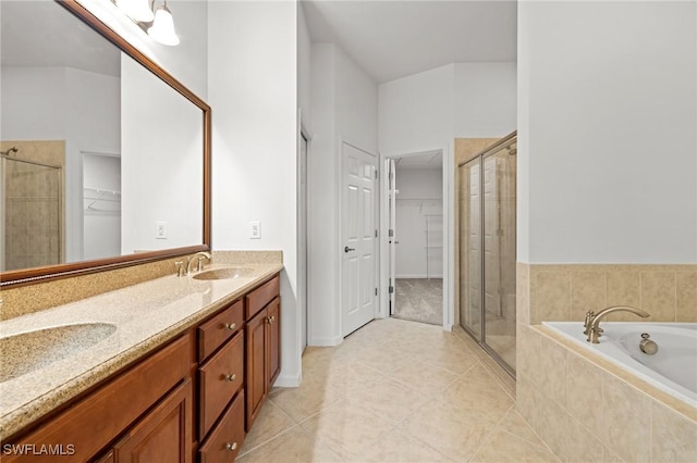 bathroom featuring tile patterned flooring, vanity, and separate shower and tub